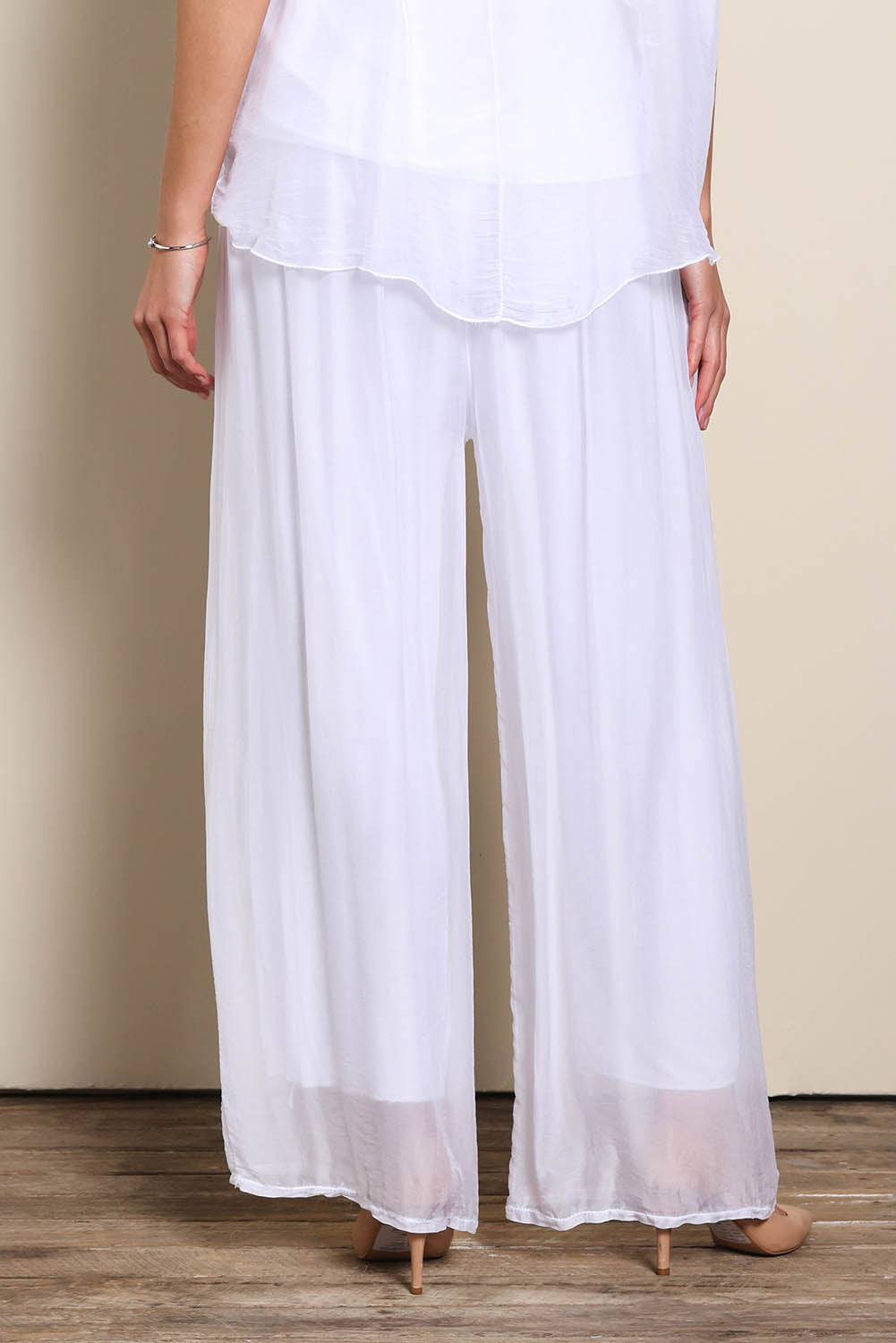 Model Maddiec wearing size 10 of the Silk Pant - White in colour White, in a cropped view