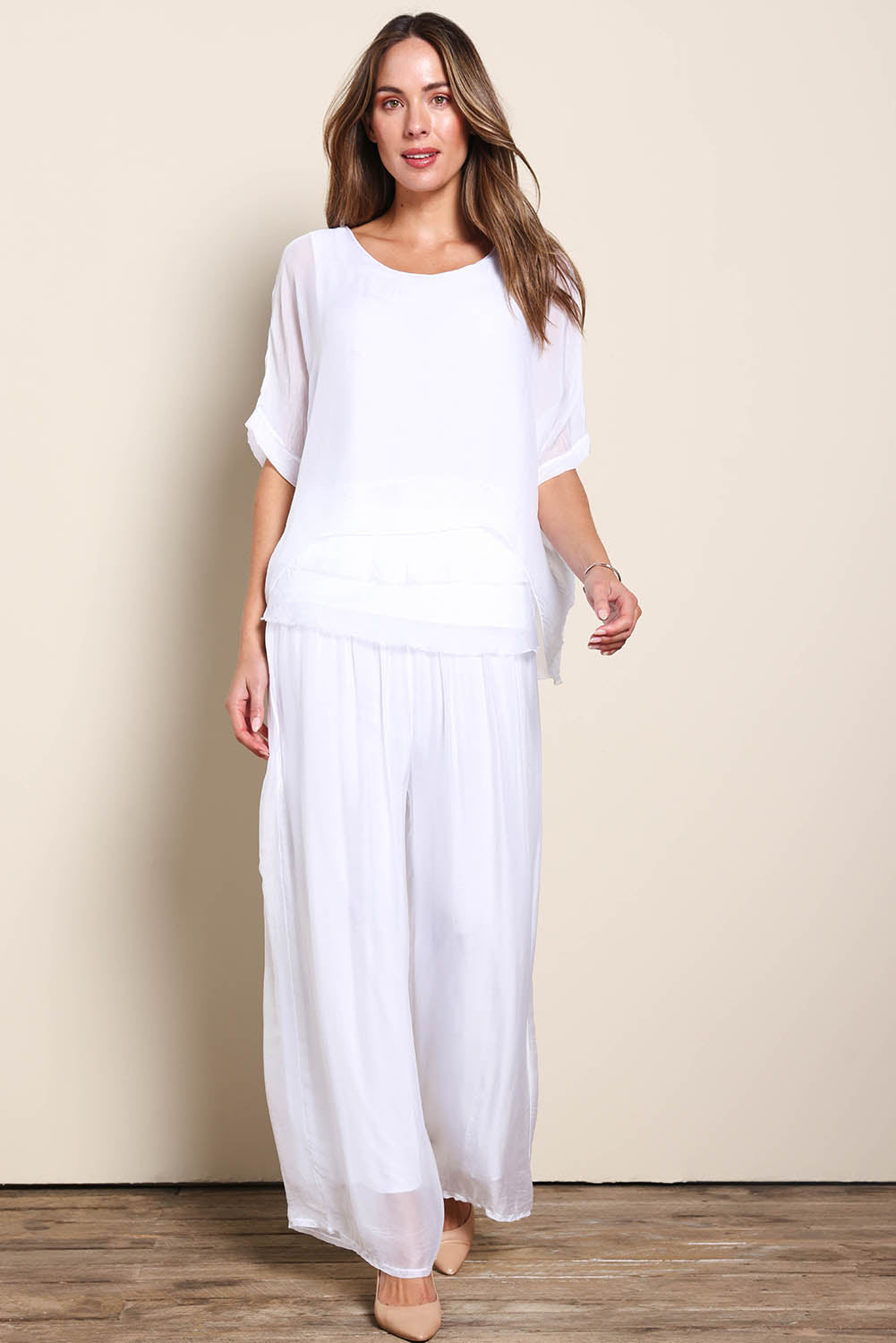 Model Maddiec wearing size 10 of the Silk Pant - White in colour White, from the front
