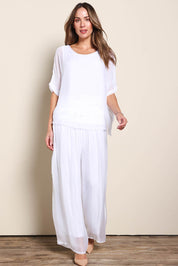 Model Maddiec wearing size 10 of the Silk Pant - White in colour White, from the front
