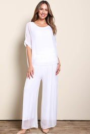Model Maddiec wearing size 10 of the Silk Pant - White in colour White, from the front