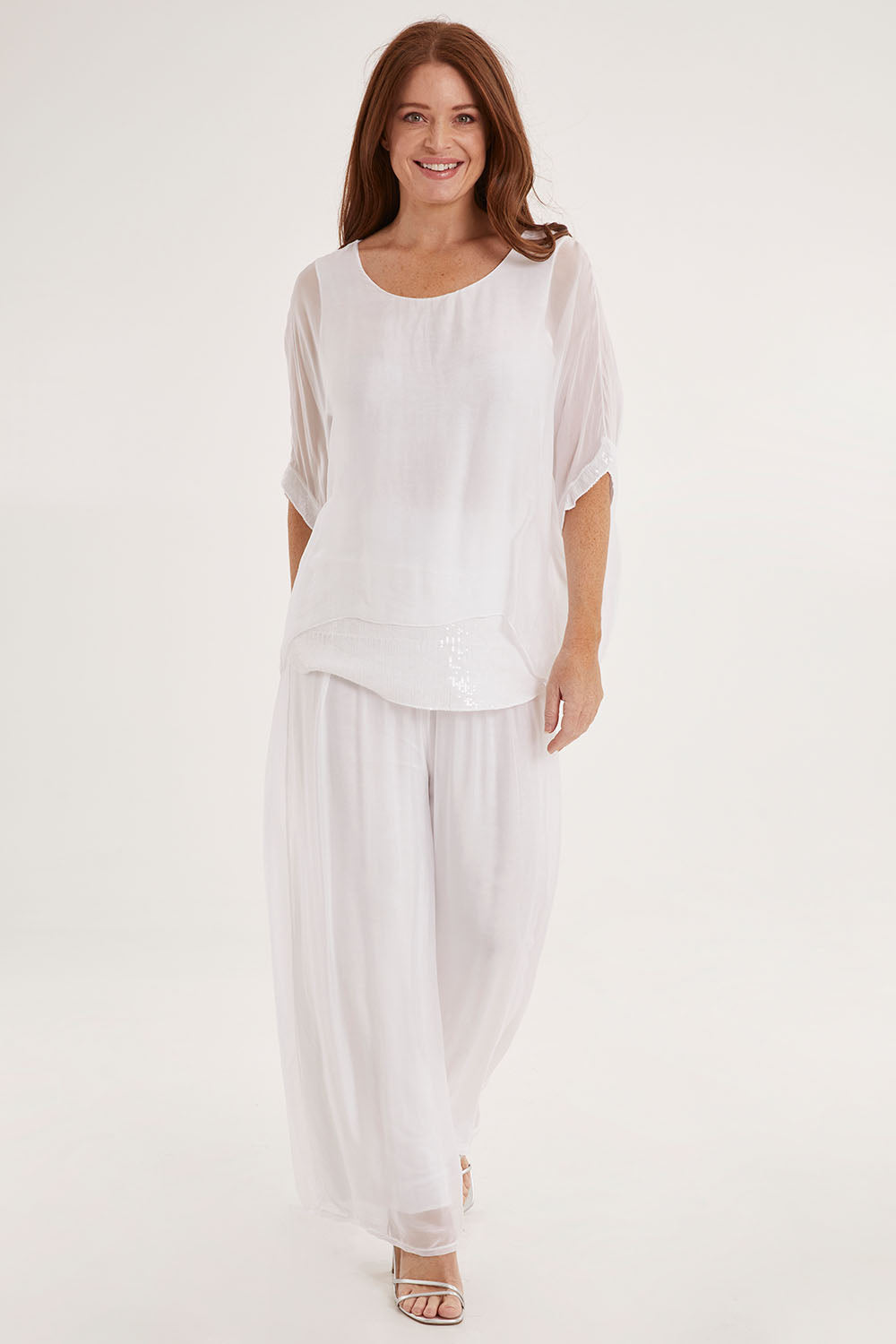 Model Sally wearing the Silk Pant in colour White (White), from the front, showing the whole outfit