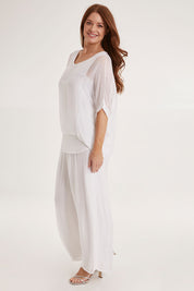 Model Sally wearing the Silk Pant in colour White (White), from the front, showing the whole outfit