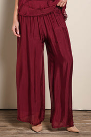 Model Maddiec wearing size 10 of the Silk Pant - Wine in colour Wine, in a cropped view
