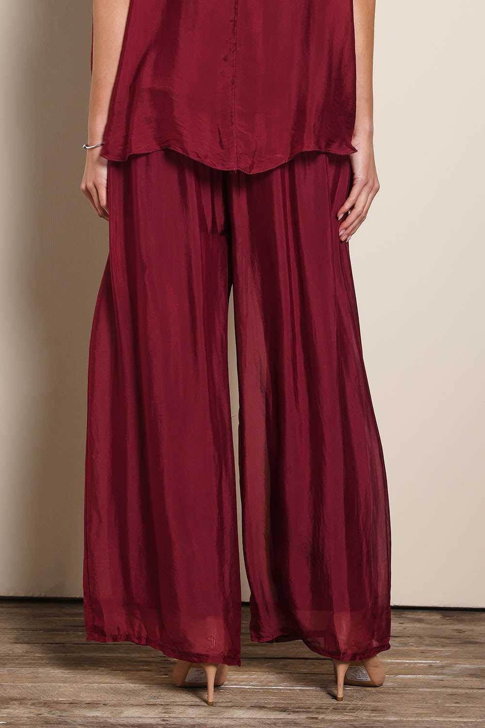 Model Maddiec wearing size 10 of the Silk Pant - Wine in colour Wine, from the front