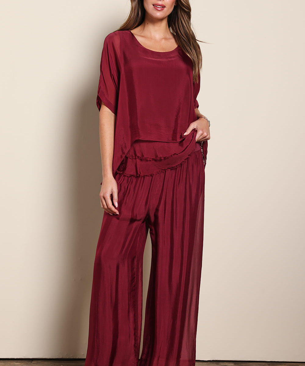 Model Madelinec wearing size 10 of the Silk Pant - Wine in colour Wine, from the front