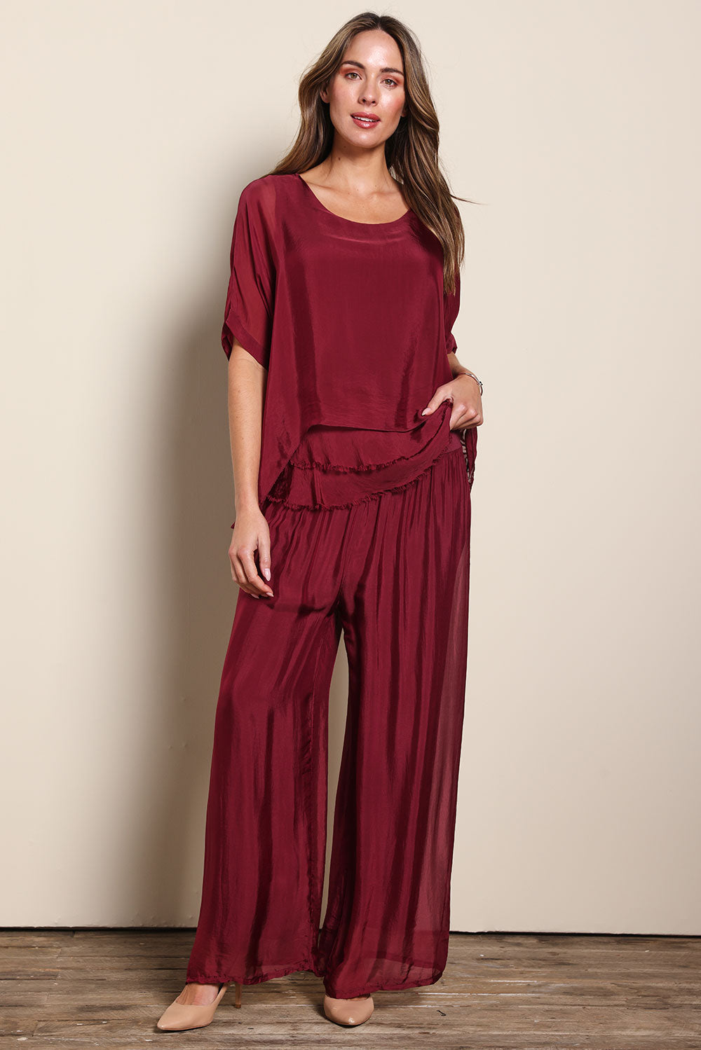 Model Madelinec wearing size 10 of the Silk Pant - Wine in colour Wine, from the front