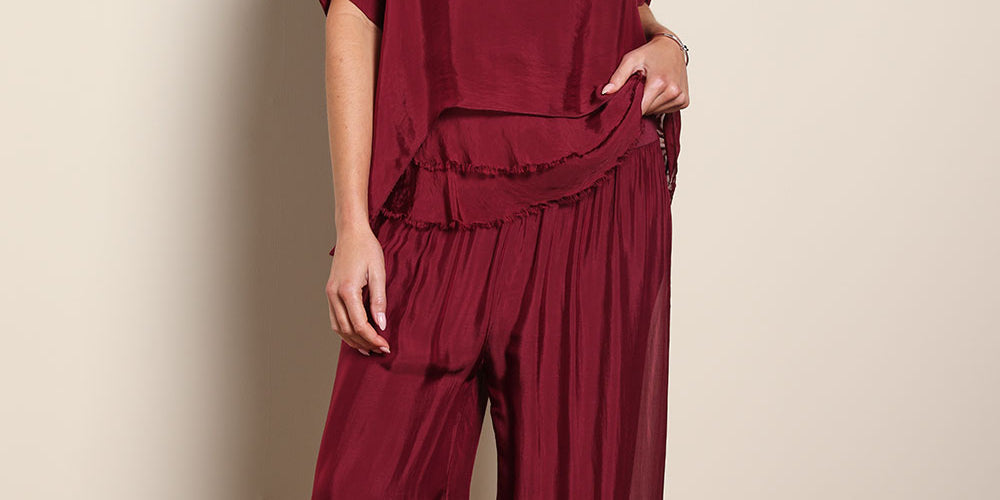 Model Madelinec wearing size 10 of the Silk Pant - Wine in colour Wine, from the front