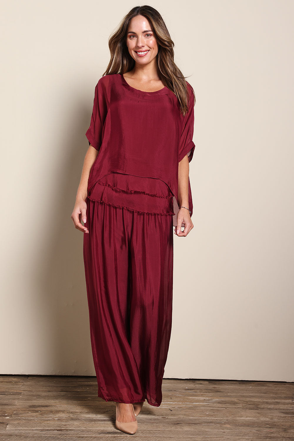 Model Madelinec wearing size 10 of the Silk Pant - Wine in colour Wine, from the front