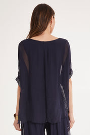 Model Madeline wearing the Silk Sequin Top in colour Navy (Blue), from the back