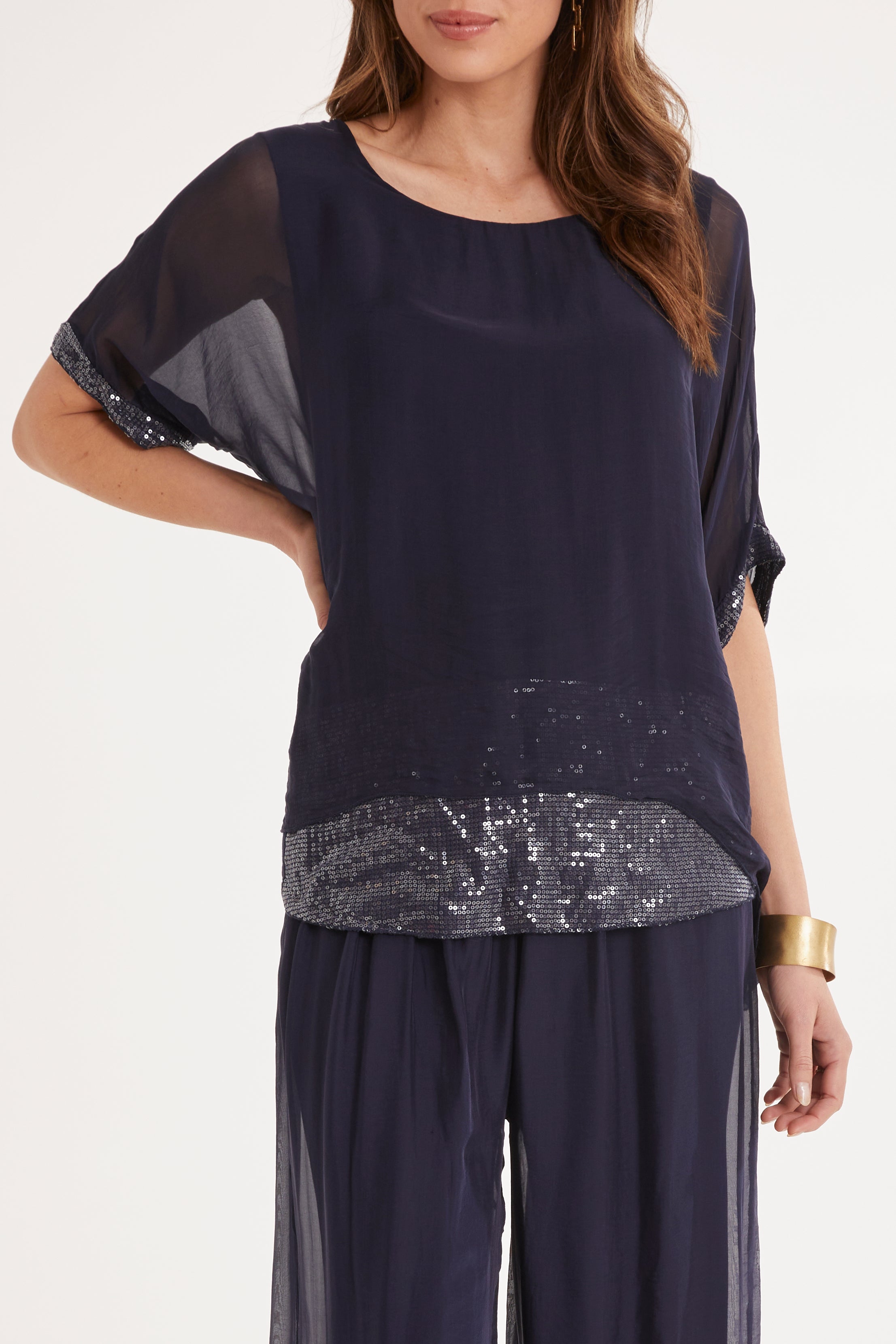 Model Madeline wearing the Silk Sequin Top in colour Navy (Blue), from the front, cropped image