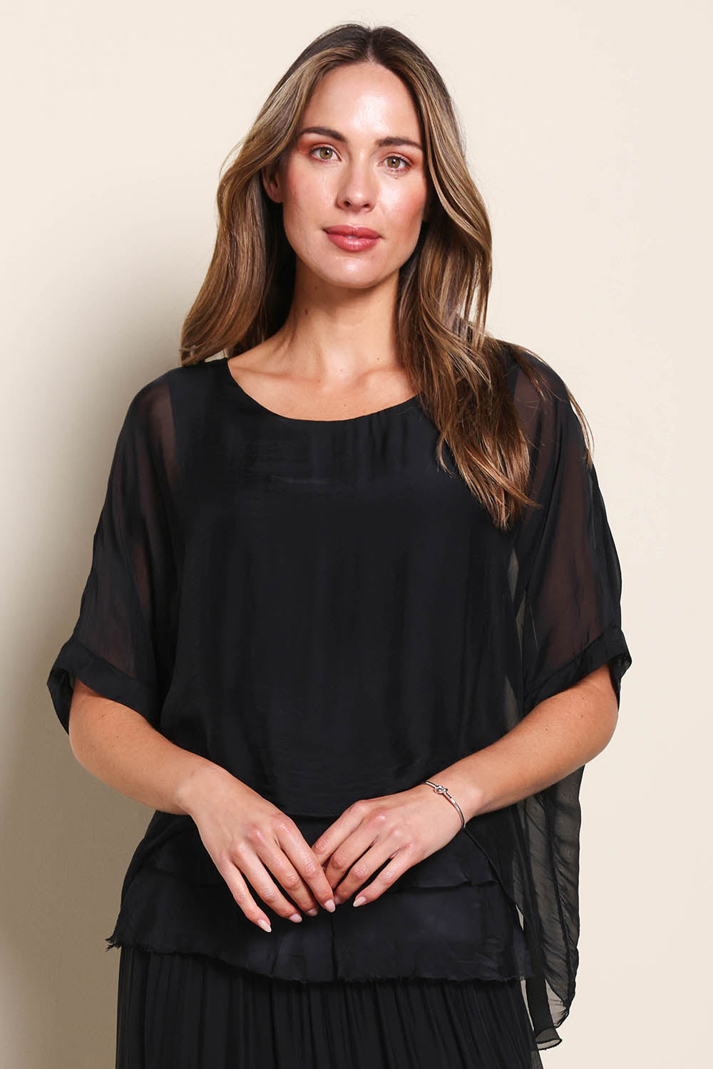Model Maddiec wearing size 10 of the Silk Blend Three Layer Raw Edge Top - Black in colour Black, in a cropped view