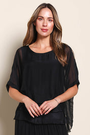 Model Maddiec wearing size 10 of the Silk Blend Three Layer Raw Edge Top - Black in colour Black, in a cropped view