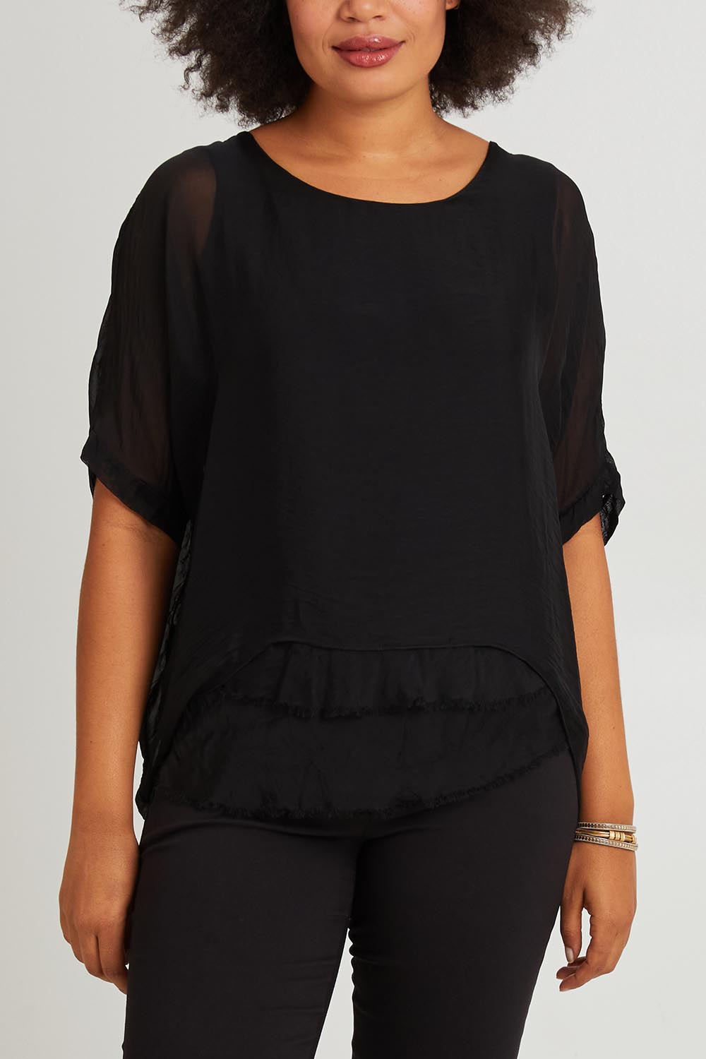 Model Olivia wearing the Silk Blend Three Layer Raw Edge Top in colour Black (Black), from the front, cropped image