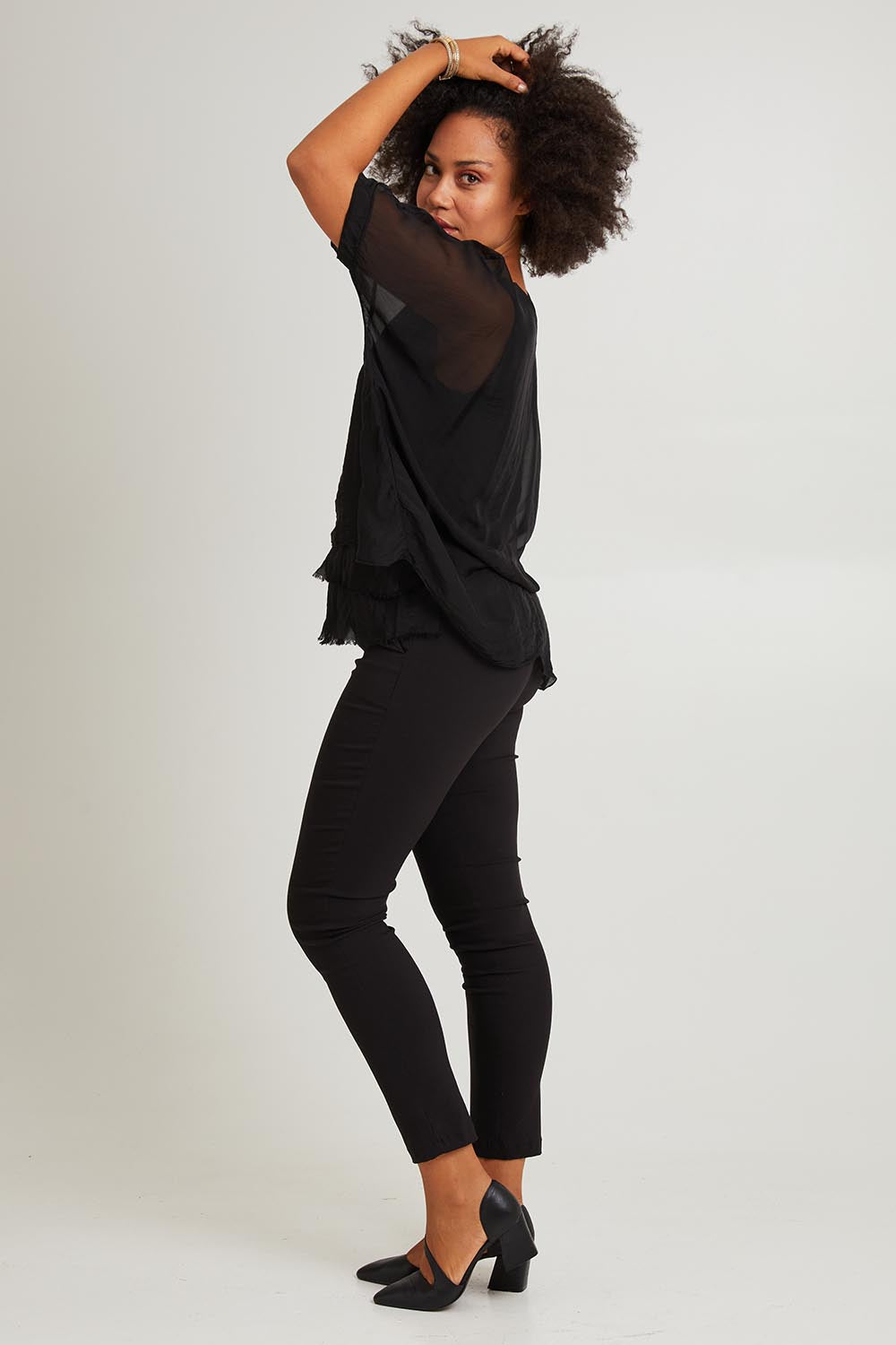 Model Olivia wearing the Silk Blend Three Layer Raw Edge Top in colour Black (Black), from the front, showing the whole outfit