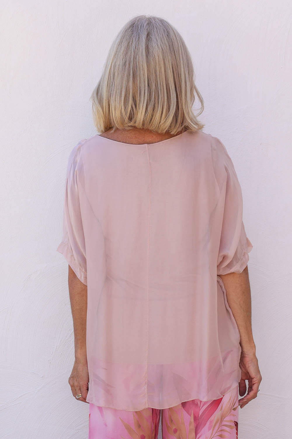 Model Sandy wearing the Silk Blend Three Layer Raw Edge Top in colour Blushpink (Pink), from the back