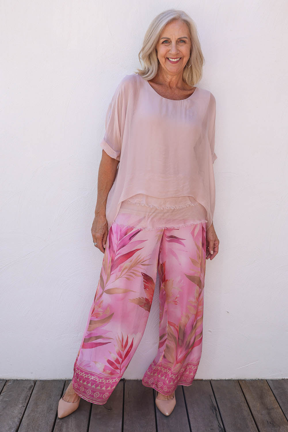 Model Sandy wearing the Silk Blend Three Layer Raw Edge Top in colour Blushpink (Pink), from the front, showing the whole outfit