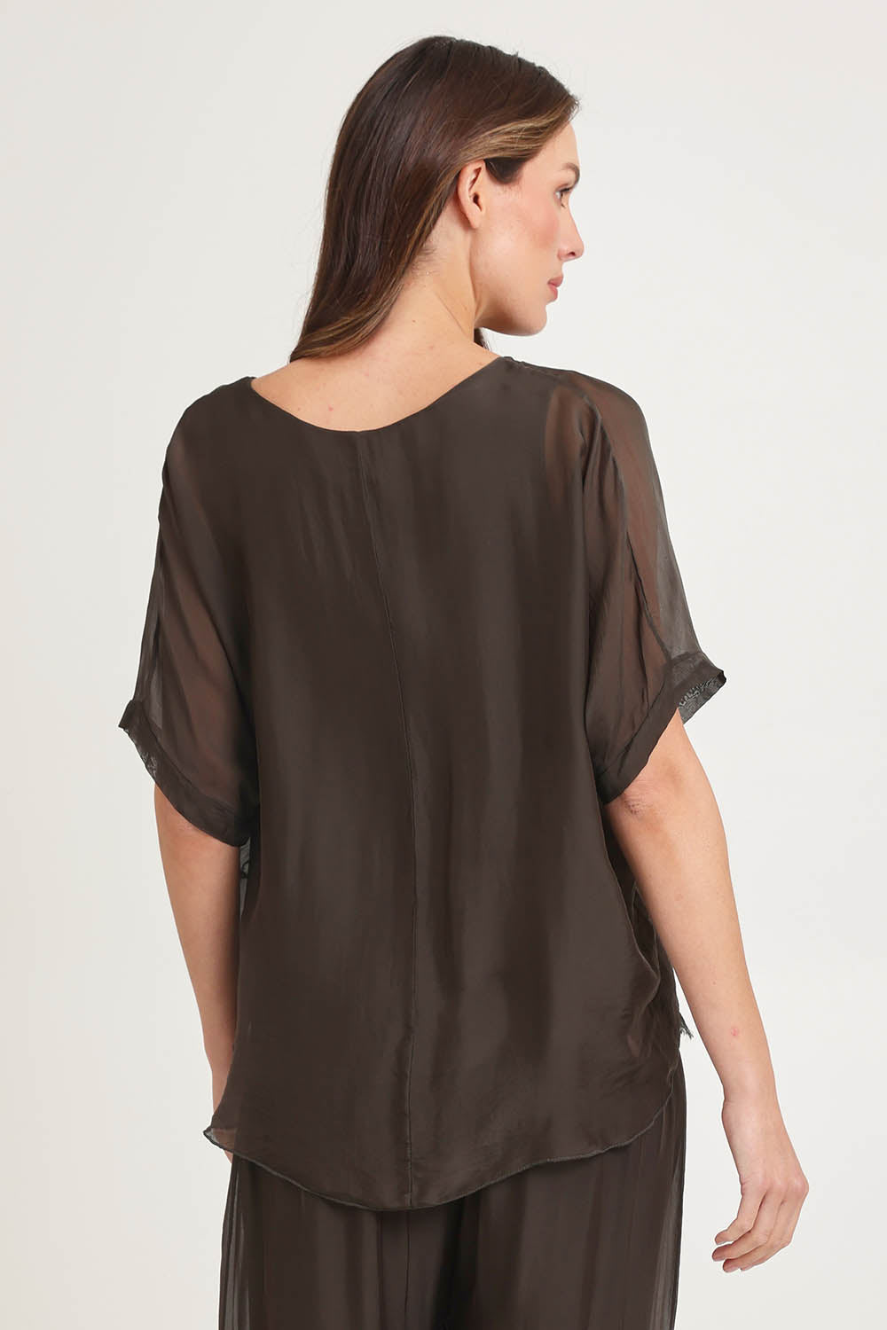 Model Madeline wearing the Silk Blend Three Layer Raw Edge Top in colour Moro, from the back
