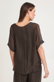 Model Madeline wearing the Silk Blend Three Layer Raw Edge Top in colour Moro, from the back