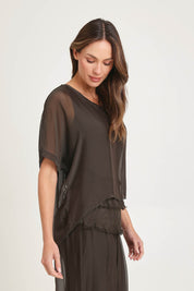Model Madeline wearing the Silk Blend Three Layer Raw Edge Top in colour Moro, from the front, cropped image