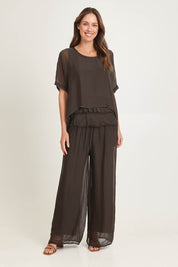 Model Madeline wearing the Silk Blend Three Layer Raw Edge Top in colour Moro, from the front, showing the whole outfit