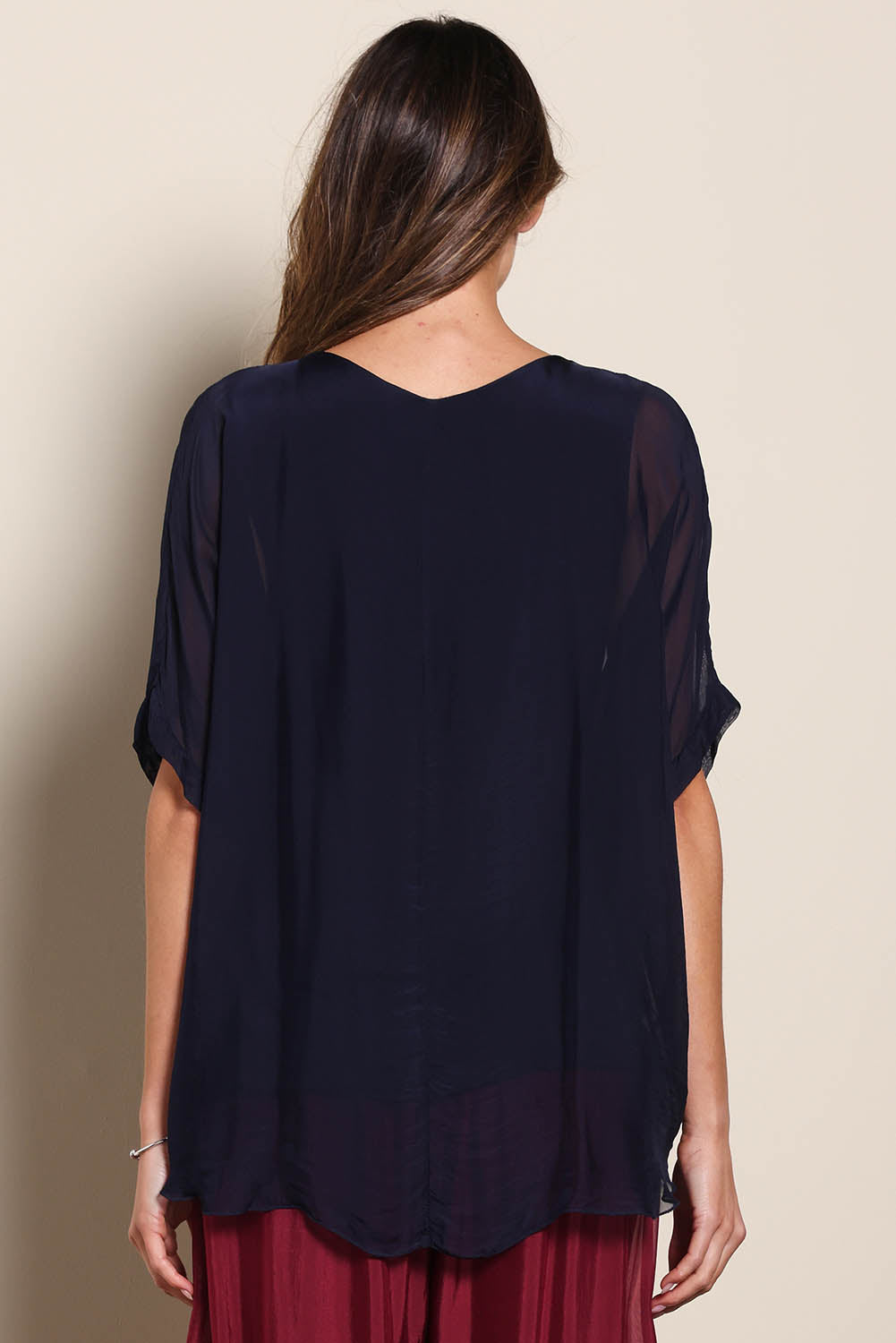 Model Maddiec wearing size 10 of the Silk Blend Three Layer Raw Edge Top - Navy in colour Navy, from the back