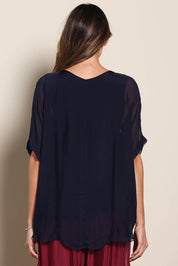 Model Maddiec wearing size 10 of the Silk Blend Three Layer Raw Edge Top - Navy in colour Navy, from the back