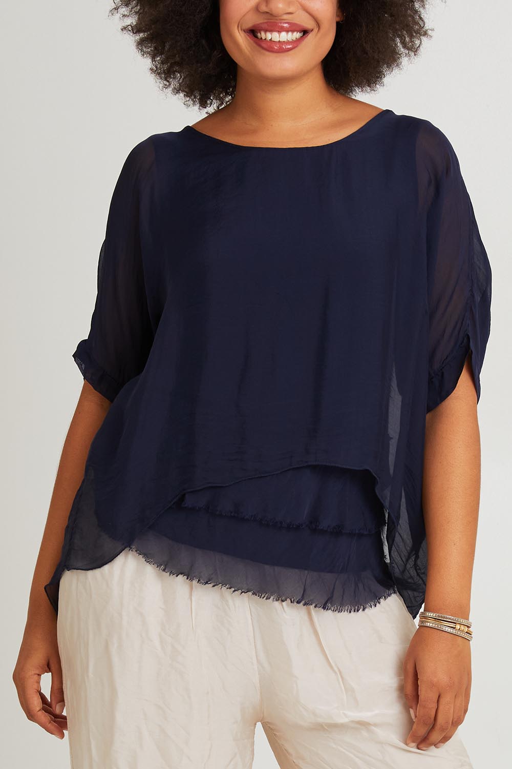 Model Olivia wearing the Silk Blend Three Layer Raw Edge Top in colour Navy (Blue), from the front, cropped image