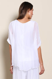 Model Maddiec wearing size 10 of the Silk Blend Three Layer Raw Edge Top - White in colour White, from the back