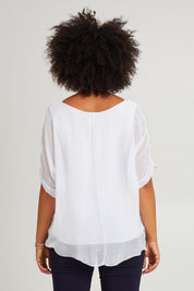Model Olivia wearing the Silk Blend Three Layer Raw Edge Top in colour White (White), from the back