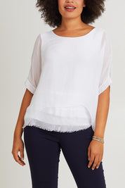 Model Olivia wearing the Silk Blend Three Layer Raw Edge Top in colour White (White), from the front, cropped image