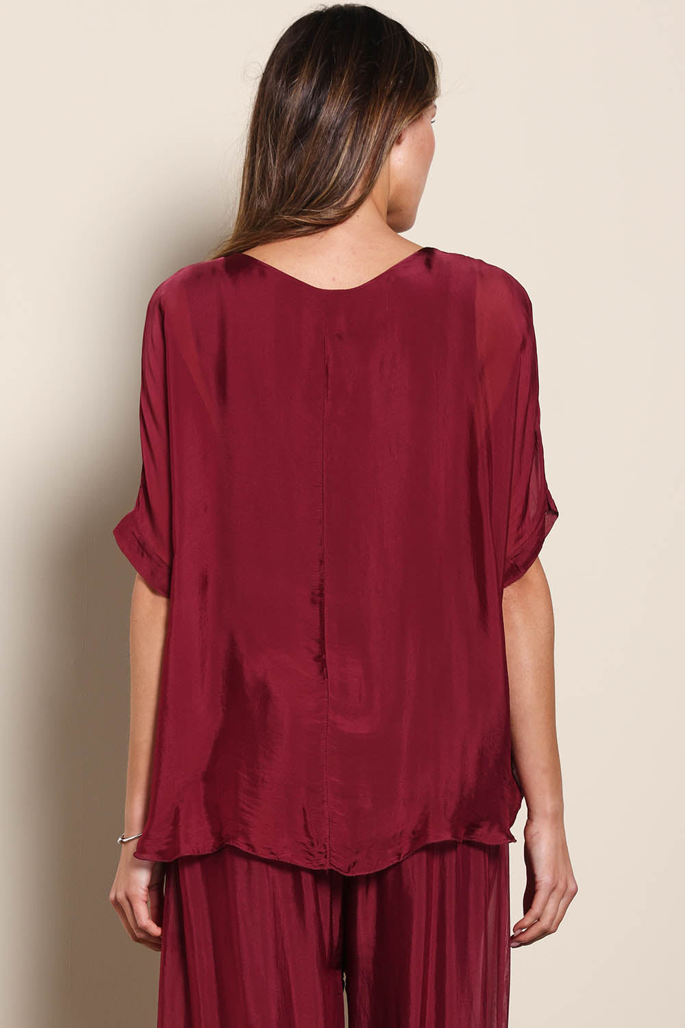 Model Maddiec wearing size 10 of the Silk Blend Three Layer Raw Edge Top - Wine in colour Wine, from the back