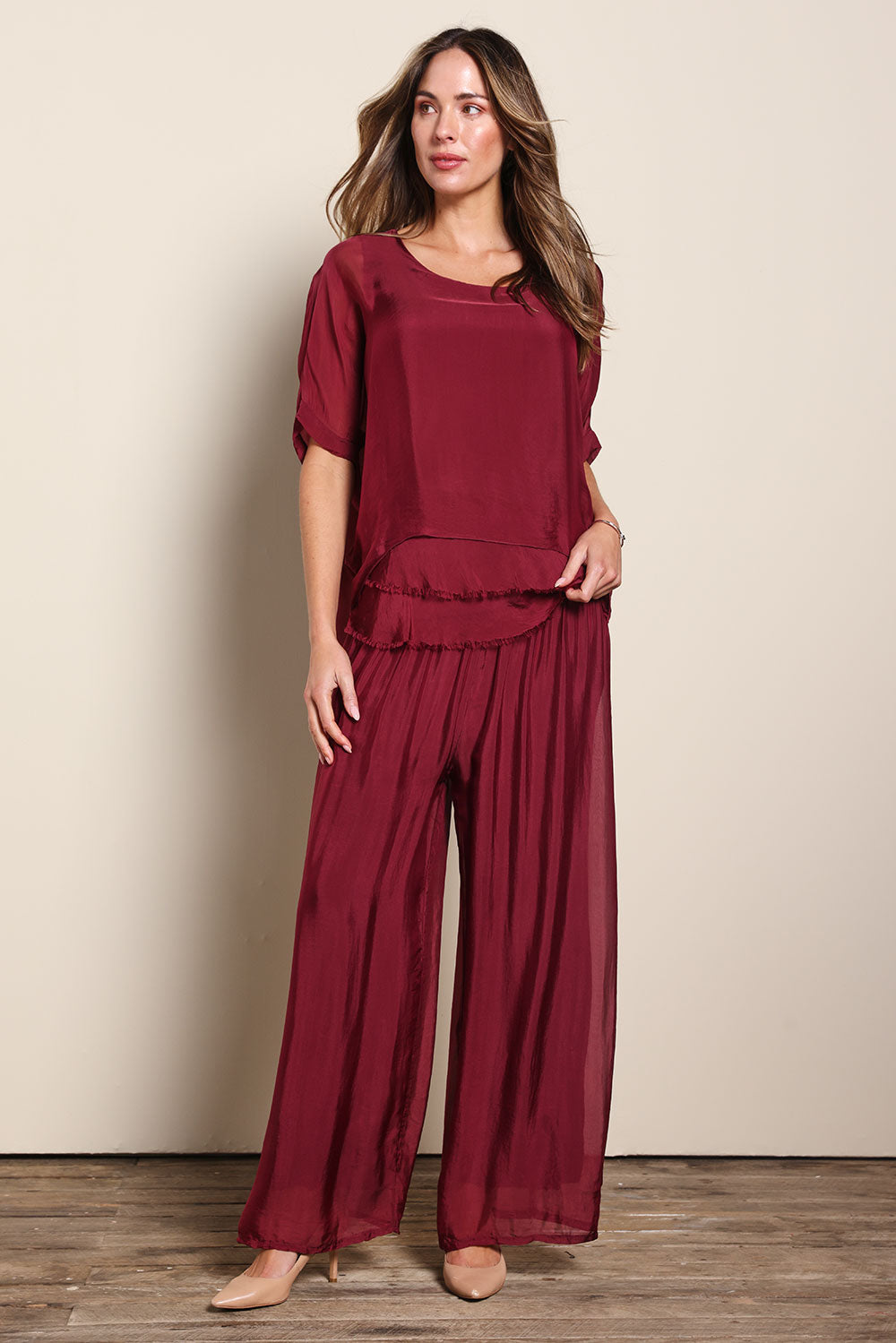 Model Madelinec wearing size 10 of the Silk Blend Three Layer Raw Edge Top - Wine in colour Wine, from the front
