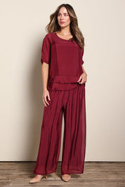 Model Madelinec wearing size 10 of the Silk Blend Three Layer Raw Edge Top - Wine in colour Wine, from the front