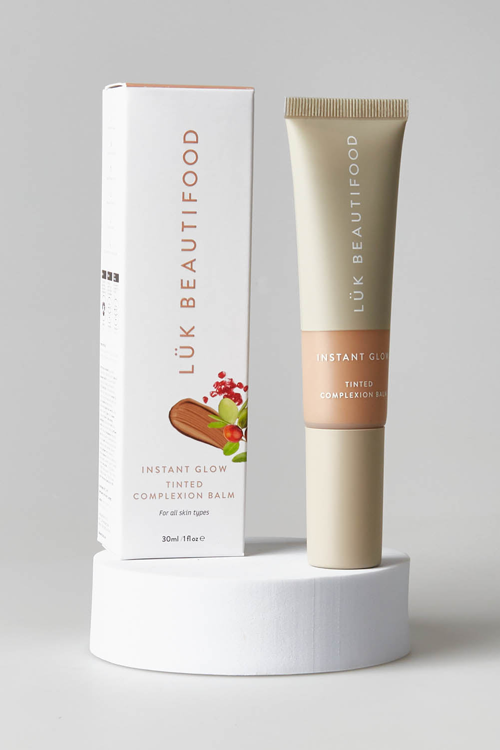 A model wearing size OneSize of the Tinted Complexion Balm in colour Tan, from the front, showing the whole outfit