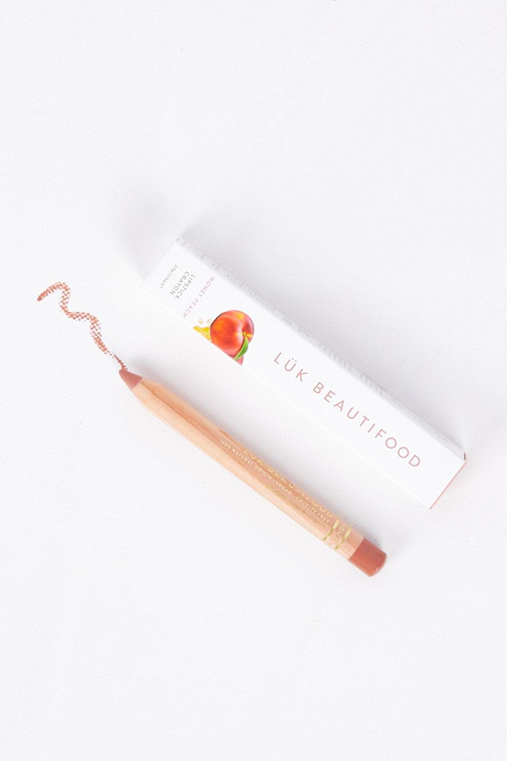 A model wearing size OneSize of the Lipstick Crayon Replenishment in colour Honeypeach (Pink), from the front, showing the whole outfit