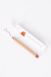 A model wearing size OneSize of the Lipstick Crayon Replenishment in colour Honeypeach (Pink), from the front, showing the whole outfit