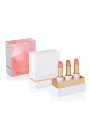A model wearing the Lip Nourish Trio in colour Shimmers (Pink), from the front, showing the whole outfit