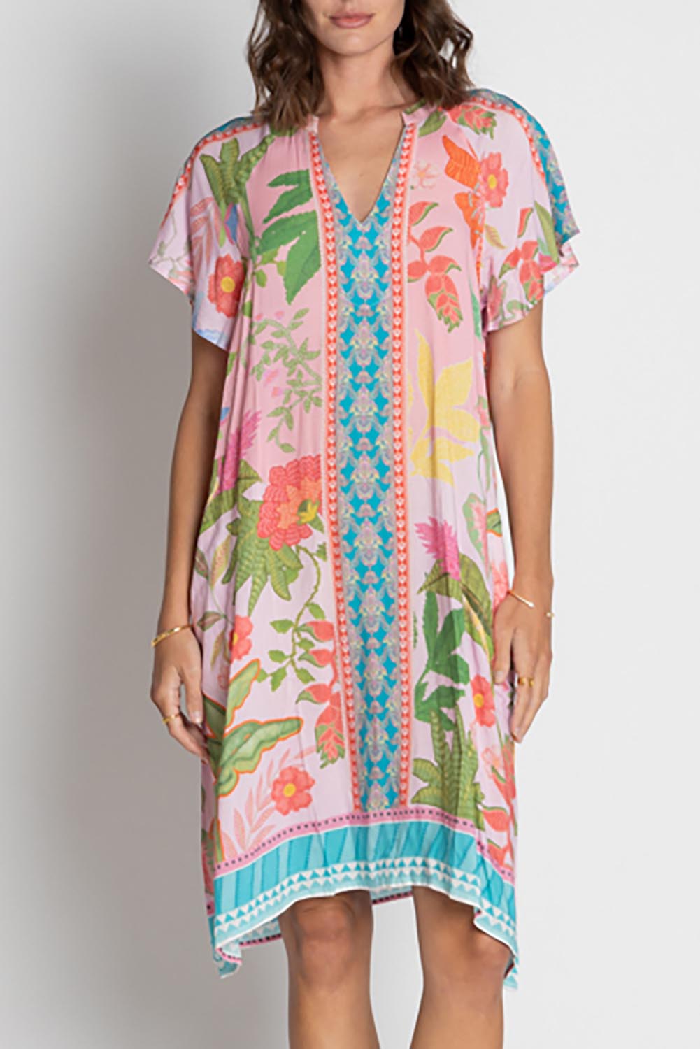 A model wearing the Anassa Dress in colour Orchidpi, from the front, cropped image