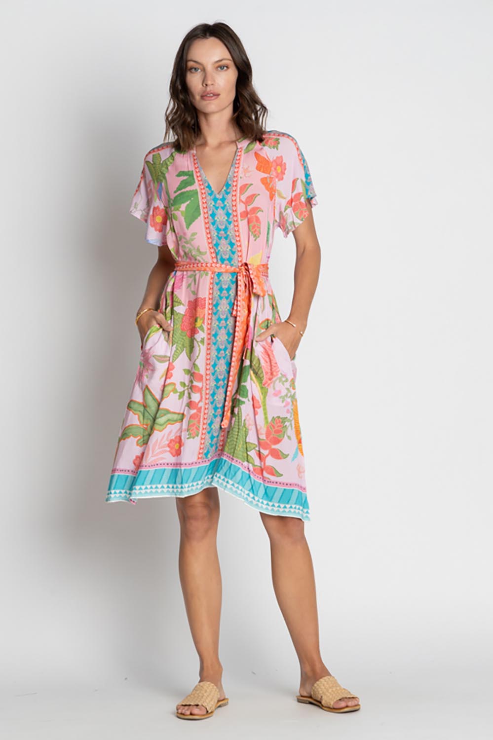 A model wearing the Anassa Dress in colour Orchidpi, from the front, showing the whole outfit