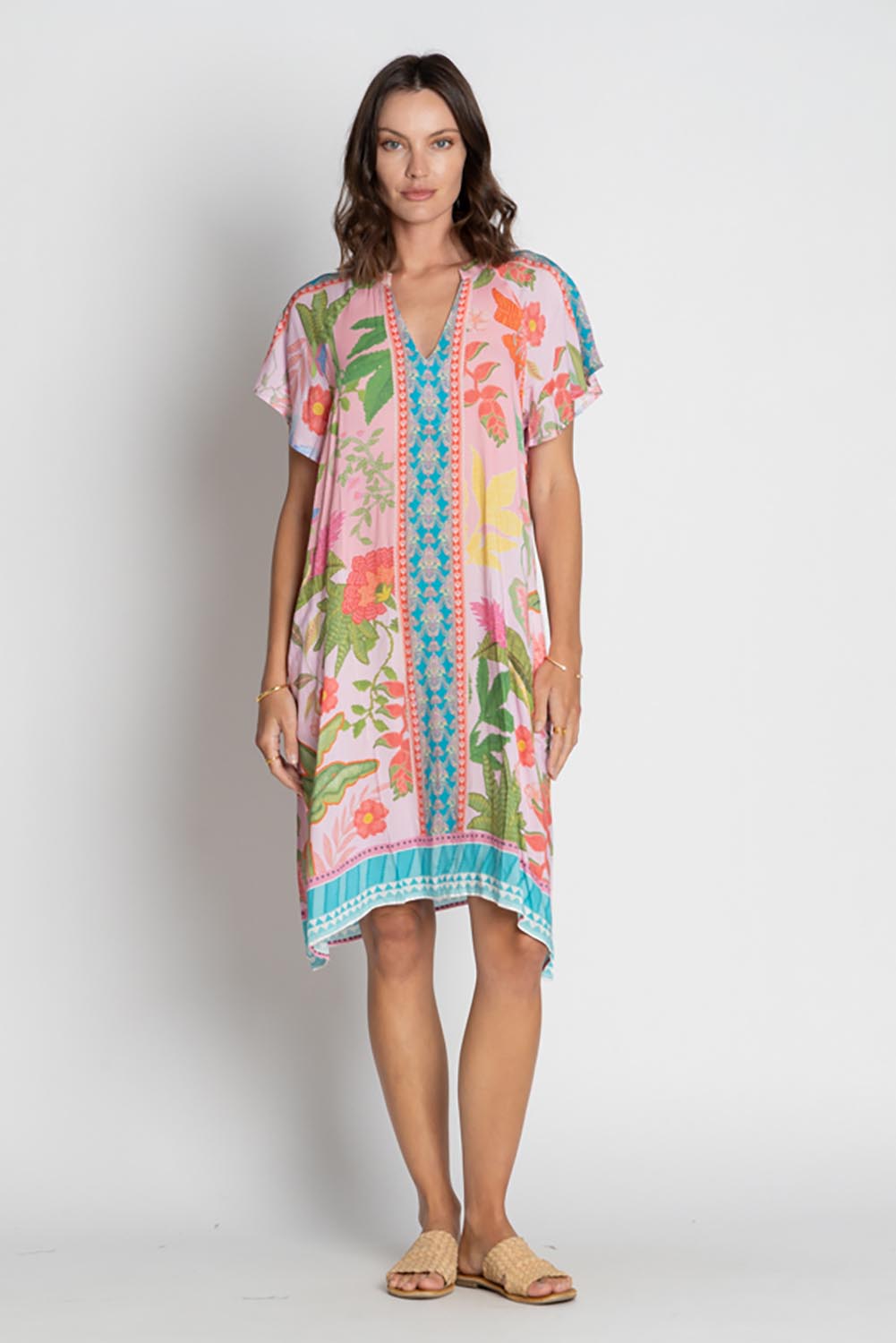 A model wearing the Anassa Dress in colour Orchidpi, from the front, showing the whole outfit