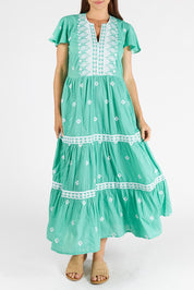 A model wearing the Antigua Maxi Cotton Dress in colour Sea (Green), from the front, cropped image