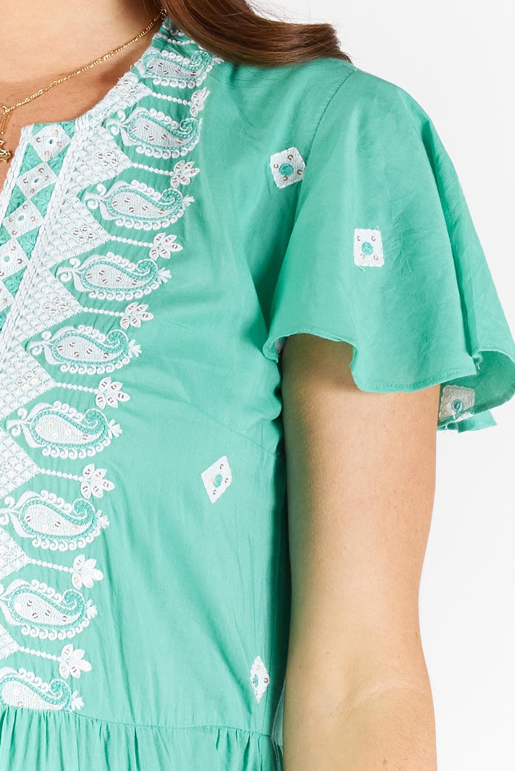 A model wearing the Antigua Maxi Cotton Dress in colour Sea (Green), from the front, cropped image