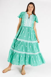 A model wearing the Antigua Maxi Cotton Dress in colour Sea (Green), from the front, showing the whole outfit