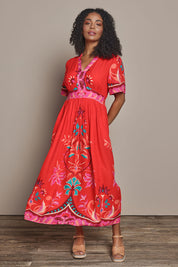 Model Ziara wearing size S of the Bahia Midi Dress in colour Geranium, from the front, showing the whole outfit