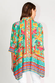 Model Madeline wearing size S of the Brasilia Kaftan Top in colour Sea (Green), from the back