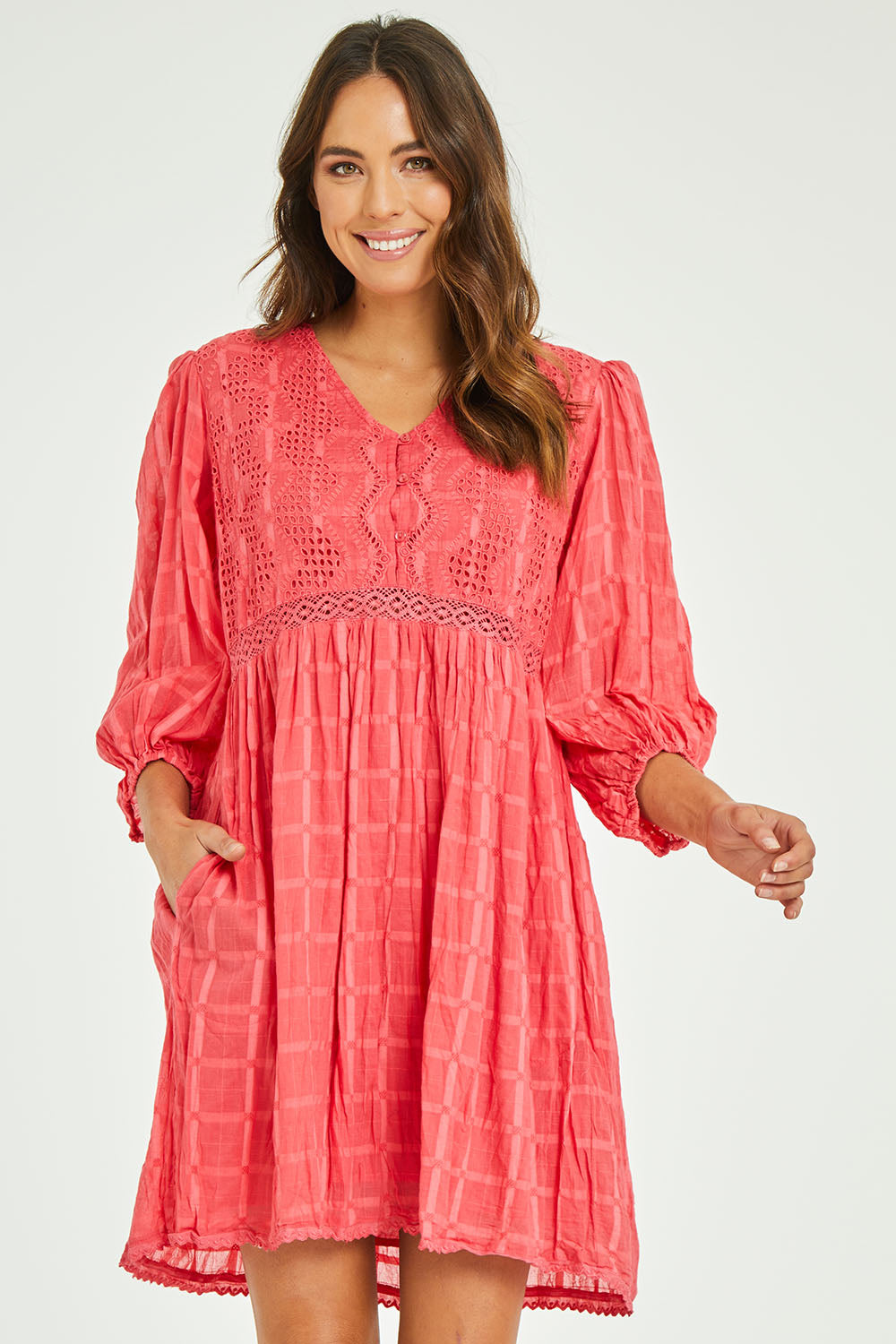 Model Madeline wearing size S of the Byron Dress in colour Melon (Pink), from the front, cropped image