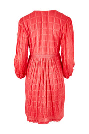 Product shot of the Byron Dress in colour Melon (Pink), from the back