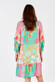 A model wearing the Camargue Dress in colour Lagoon (Green), from the back