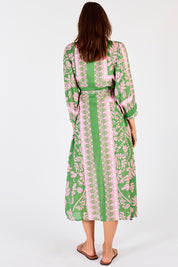 A model wearing the Carara Buttoned Midi in colour Green (Green), from the back