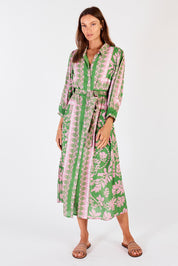 A model wearing the Carara Buttoned Midi in colour Green (Green), from the front, showing the whole outfit